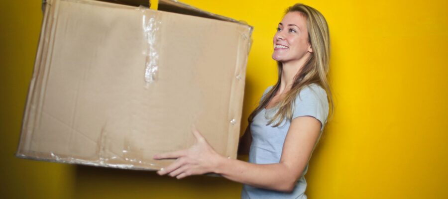 Blond woman carrying a big box