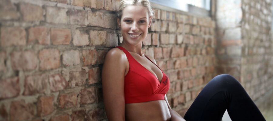Blond woman with sport red bra doing fitness